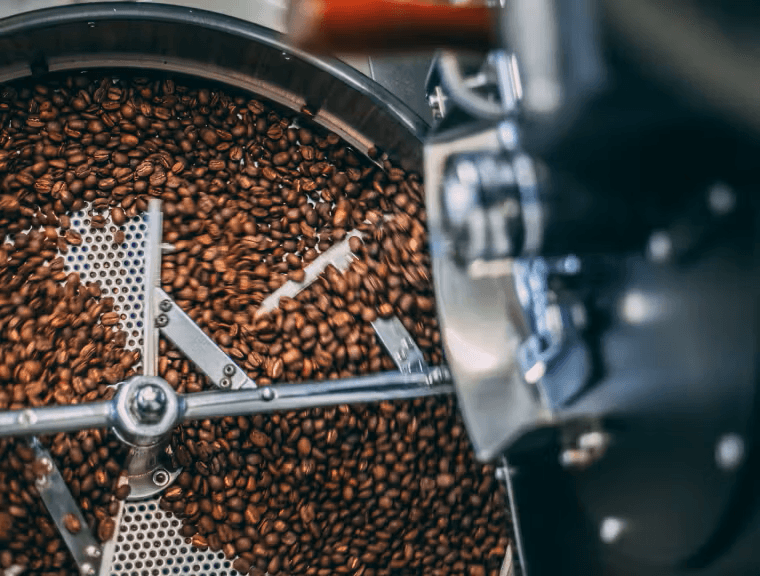 Freshly roasted Ethiopian coffee beans on a wooden scoop